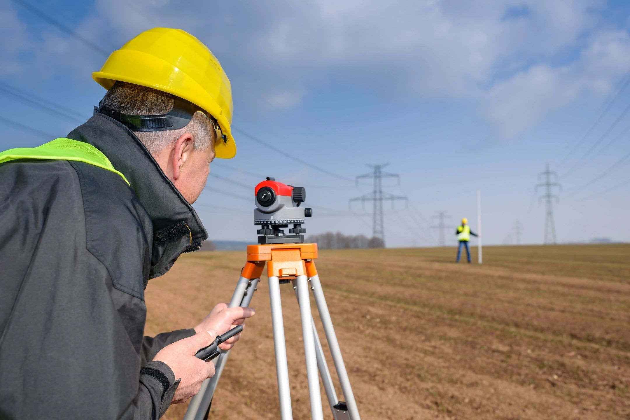 Surveyor operating field equipment